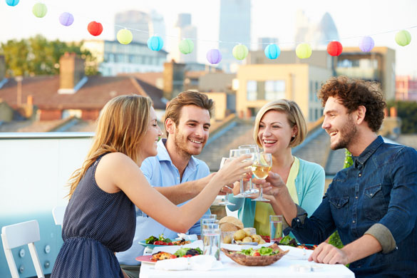 Group-Of-Friends-Eating-Meal-On-Rooftop-Terrace