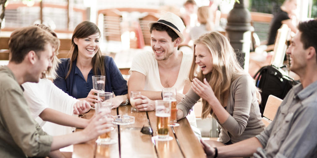 Young people drinking beer outdoors