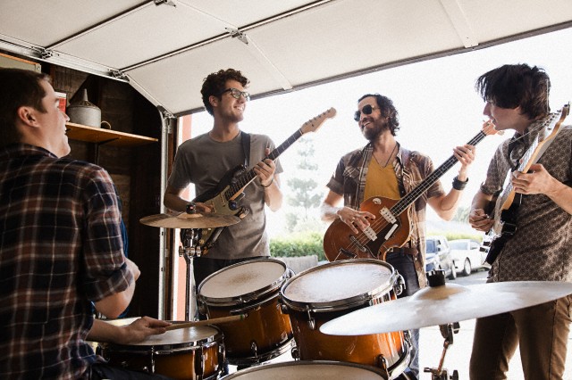 Band practicing in garage --- Image by © Greg Hinsdale/Corbis