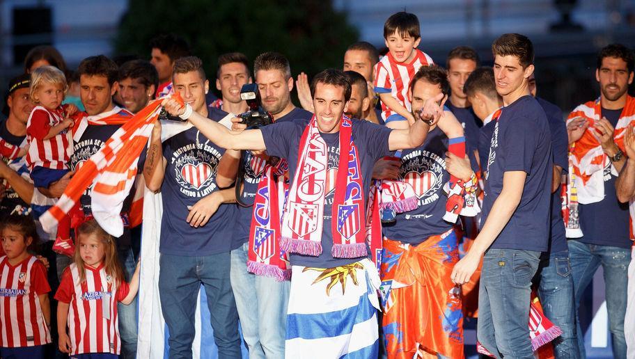 MADRID, SPAIN - MAY 18: Club Atletico de Madrid coach Diego Godin (C) celebrates after their tenth La Liga title at Neptuno Square on May 18, 2014 in Madrid, Spain. (Photo by Pablo Blazquez Dominguez/Getty Images)