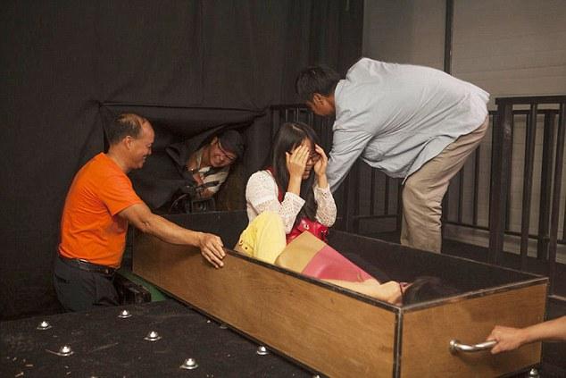 Pic shows: A theme park let punter lie in a wooden coffin in a mortuory where ghoulish ride attendants push him into a furnace. A spooky new theme park attraction where punters can experience being cremated has been flooded with crowds wanting to experience the after life. The wacky 4D Death Simulator at the Window Of The World theme park in Shenzhen in Southern China`s Guangdong Province has opened in time for Halloween and lets punters lie in a wooden coffin in a mortuary where ghoulish ride attendants push them into a furnace. Once inside, the temperature rises to a sweltering 40 degrees Celsius using heat fans. Thrilled fan Ting Shen, 22, said: "I went on it and its amazing. "You really feel like youre being burnt alive. "I feel like I died and came back. "Im definitely doing that again." A spokesman for the park said: "Its good fun and completely safe. "The customers can wander around the morgue first and then get to fell how it would be if they were cremated. "Its already proved massively popular and we expect it to be more so over the Halloween period. "People have a morbid fascination with death and the after-life and this is a good way of experiencing both." But the attraction has so far only appealed to younger crowds. Mum Yue Wan Ho, 43, said: "I went into the morgue bit with my kids who couldnt wait to get inside the coffin. "But I think its all just a little bit too weird for me. "And definitely too scary. "I think Ill wait until my time is really up before pretending it is." (ends)  