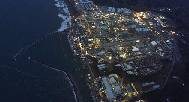 Tsunami-crippled Fukushima Daiichi nuclear power plant is illuminated for decommissioning operation in the dusk in Okuma town, Fukushima prefecture, Japan