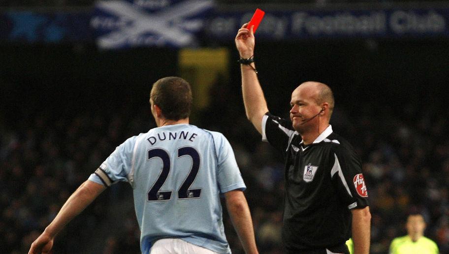 Manchester City's Richard Dunne (L) is shown the red card by referee Lee Mason against Wigan Athletic  during a Premier League football match at The City of Manchester Stadium in Manchester,  England, on January 17, 2009. AFP PHOTO / IAN KINGTON FOR EDITORIAL USE ONLY Additional licence required for any commercial/promotional use or use on TV or internet (except identical online version of newspaper) of Premier League Football League photos. Tel DataCo +44 207 2981656. Do not alter/modify photo. (Photo credit should read IAN KINGTON/AFP/Getty Images)