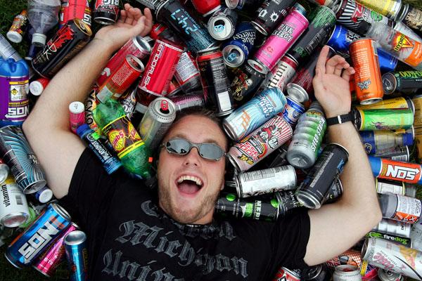 Neil Blake/Staff Photographer Grand Blanc graduate student Dusty Smith poses for a portrait surrounded by a small portion of his energy drink bottle collection. He started drinking energy drinks during the 2006-07 school year to keep up with his busy lifestyle. Since then, he has downed 376 different kinds of energy drinks. "I'll be over 400 by Christmas," Smith said.