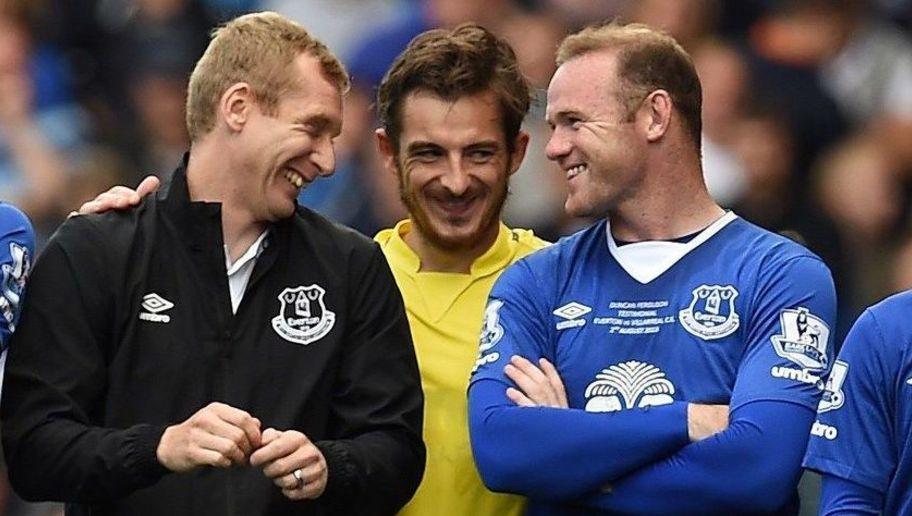 Manchester United's former Everton forward Wayne Rooney shares a joke with Everton's Leighton Baines (C) and Tony Hibbert (L) after the Duncan Ferguson Testimonal pre-season friendly football match between Everton and Villarreal at Goodison Park in Liverpool, north west England on August 2, 2015. AFP PHOTO / PAUL ELLIS RESTRICTED TO EDITORIAL USE. No use with unauthorised audio, video, data, fixture lists, club/league logos or live services. Online in-match use limited to 45 images, no video emulation. No use in betting, games or single club/league/player publications. (Photo credit should read PAUL ELLIS/AFP/Getty Images)