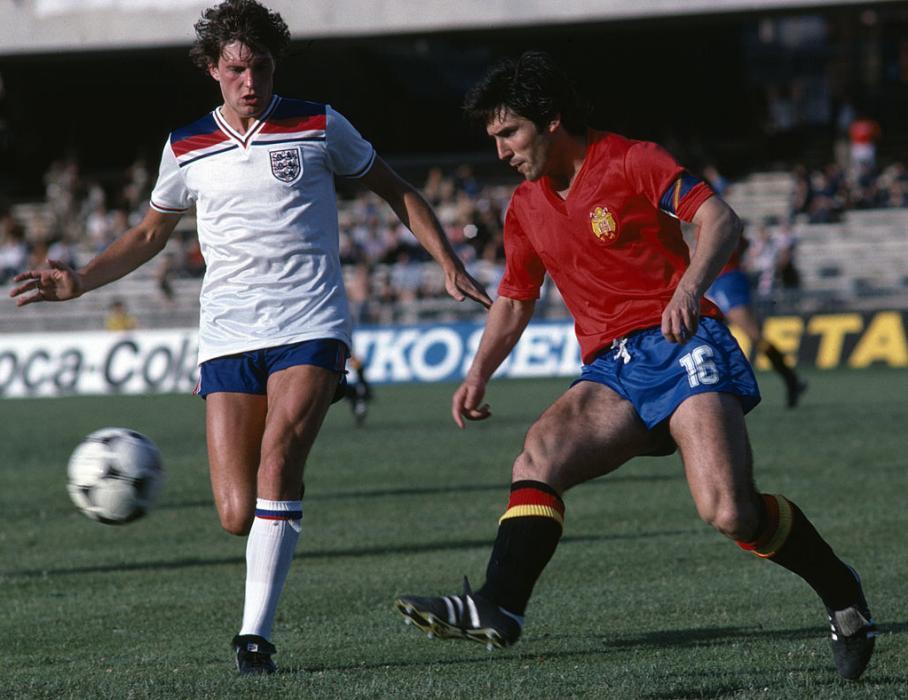 Glenn Hoddle of England (left) with Carlos Santillana of Spain during the England v Spain European Championship finals held at Stadio San Paolo in Naples, Italy on the 18th June 1980.  England won 2-1.  (Photo by Bob Thomas/Getty Images).