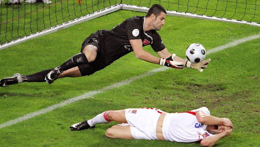 Turkish goalkeeper Volkan Demirel (L) catches a ball as Czech midfielder Jan Polak lies on the ground during the Euro 2008 final group A match Turkey vs. the Czech Republic on June 15, 2008 at the Stade de Geneve, in Geneva. The Czech Republic leads 2-1. AFP PHOTO / FABRICE COFFRINI -- MOBILE SERVICES OUT -- (Photo credit should read FABRICE COFFRINI/AFP/Getty Images)