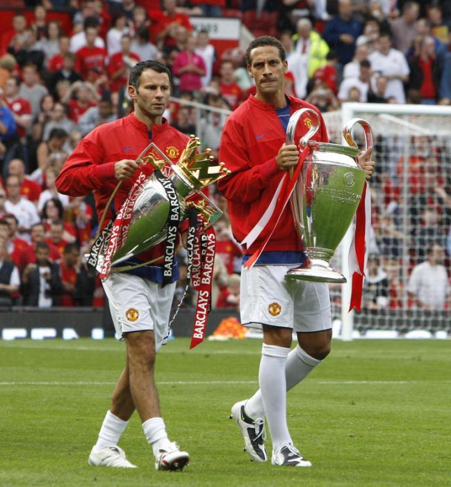 File photo dated 06-08-2008 of Manchester United's Ryan Giggs (left) and Rio Ferdinand walk with the Premier League and Champions League trophies.