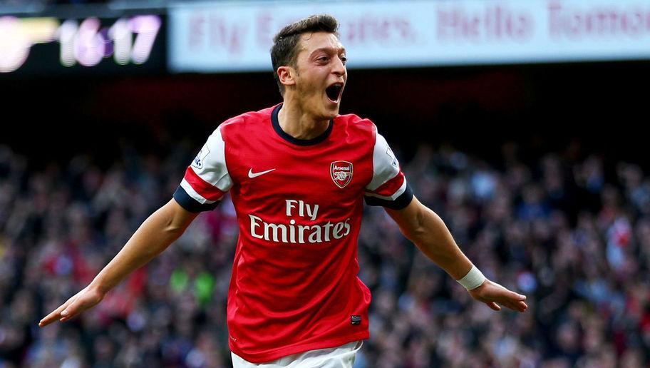 LONDON, ENGLAND - OCTOBER 19:  Mesut Oezil of Arsenal celebrates as he scores their second goal during the Barclays Premier League match between Arsenal and Norwich City at Emirates Stadium on October 19, 2013 in London, England.  (Photo by Paul Gilham/Getty Images)