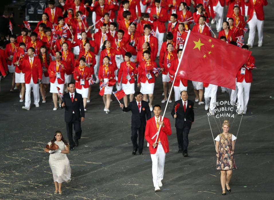 LONDON, ENGLAND - JULY 27:  Jianlian Yi of the China Olympic basketball team carries his country's flag during the Opening Ceremony of the London 2012 Olympic Games at the Olympic Stadium on July 27, 2012 in London, England.  (Photo by Clive Rose/Getty Images)