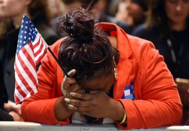 TOPSHOT - Marta Lunez, supporter of US Democratic presidential nominee Hillary Clinton, reacts to elections results during election night at the Jacob K. Javits Convention Center in New York on November 8, 2016. / AFP PHOTO / DON EMMERTDON EMMERT/AFP/Getty Images